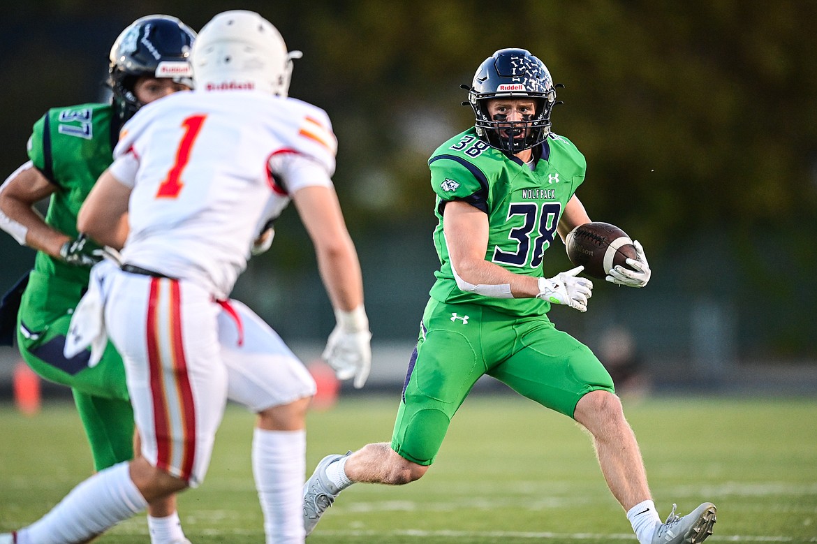 Glacier wide receiver Carson Baker (38) looks for running room in the first quarter against Missoula Hellgate at Legends Stadium on Friday, Sept. 27. (Casey Kreider/Daily Inter Lake)