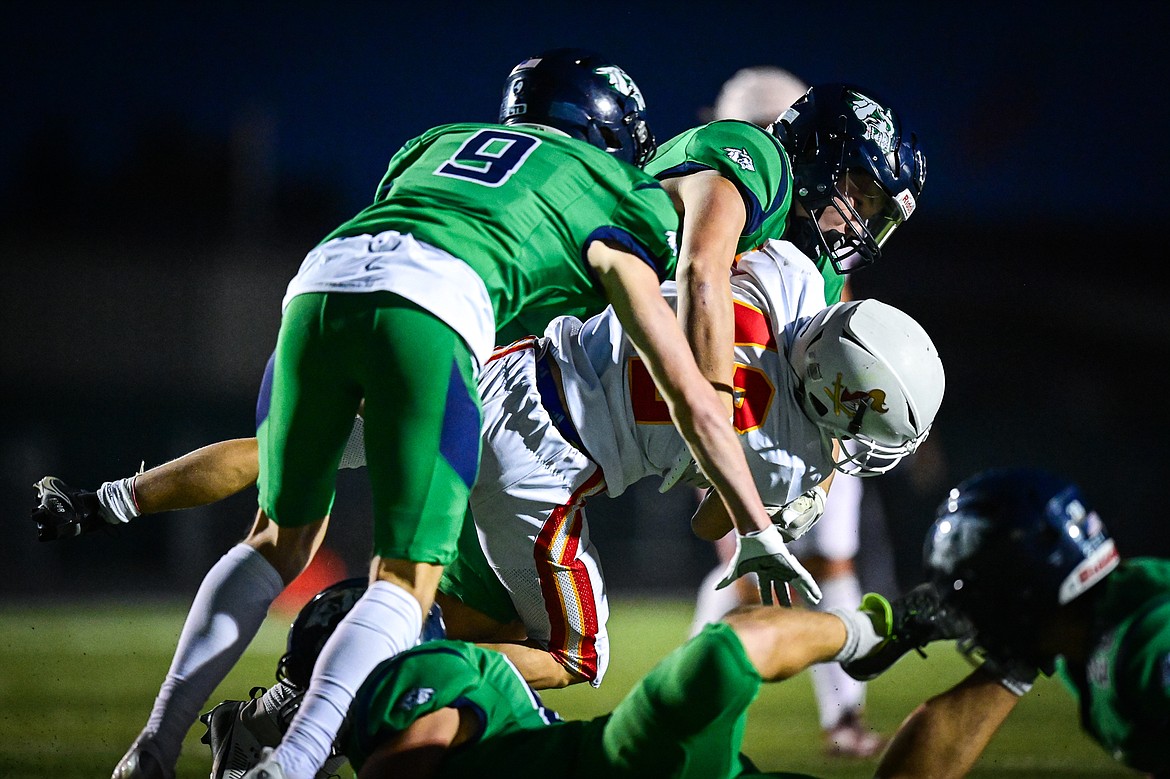 Glacier defenders Gavin Alexander (9) and Hunter Daniels (13) bring down Missoula Hellgate kick returner Oliver Caton (42) on a return in the second quarter at Legends Stadium on Friday, Sept. 27. (Casey Kreider/Daily Inter Lake)