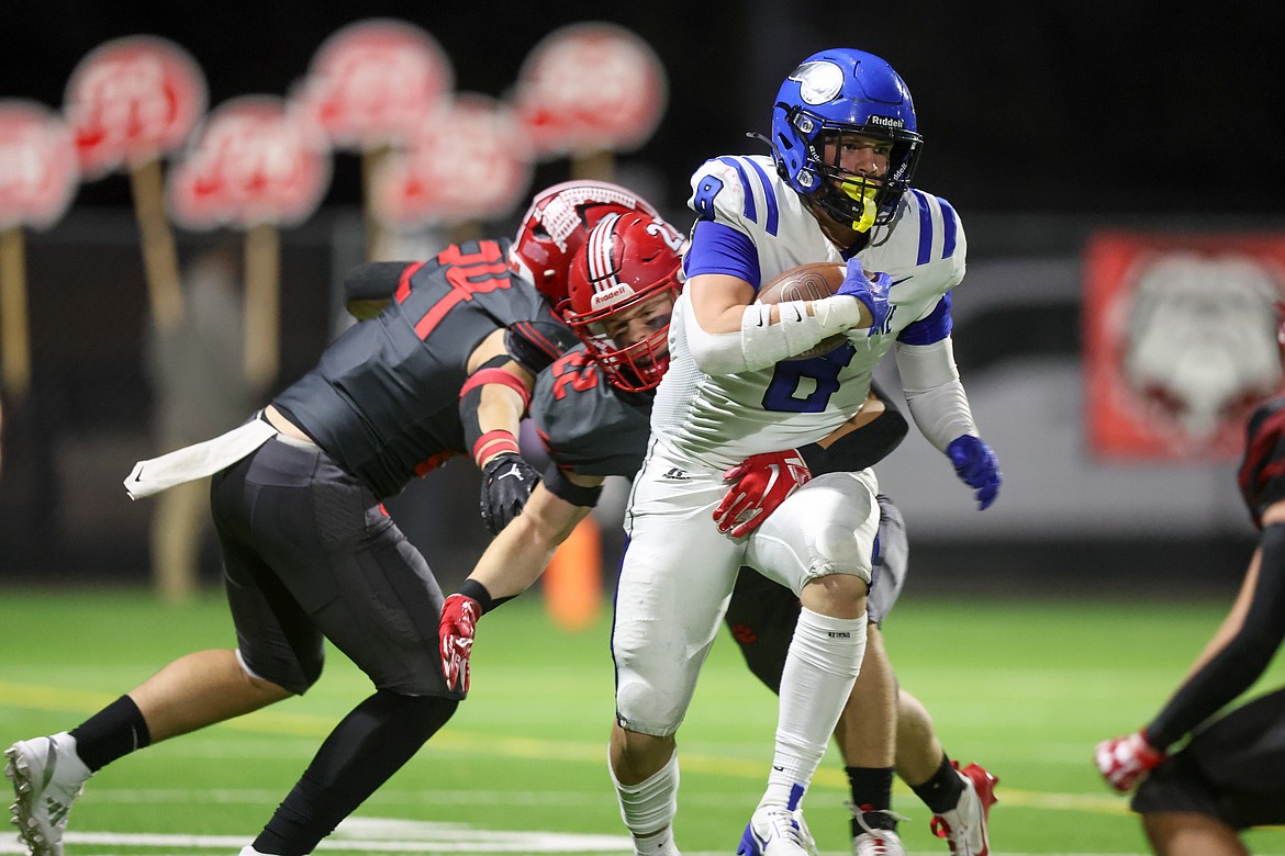 JASON DUCHOW PHOTOGRAPHY
Tucker Booth (8) of Coeur d'Alene runs with the football on Friday night at Sandpoint.