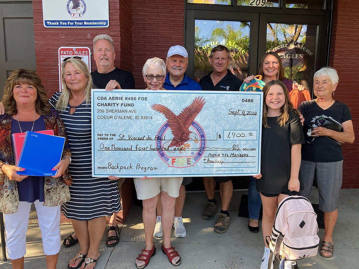 The Coeur d'Alene Eagles 486 Auxiliary and Aerie donated $1,400 in August to St. Vincent de Paul North Idaho's Backpack Program. From left: Auxiliary Trustee Debbie Magnuson, Auxiliary Vice President Laura LaChapelle, Aerie President Ron Strobel, Auxiliary Inside Guard Glenna Knepper, Aerie Trustee Rod Stack, Aerie State Past President Terry Steiner and St. Vincent De Paul North Idaho ICARE Program prevention coordinator Taryn Molitor, with Tenley Molitor, 10, who helped at least 20 hours for the backpack and supplies program, and Julie Robinson, Auxiliary chaplain.