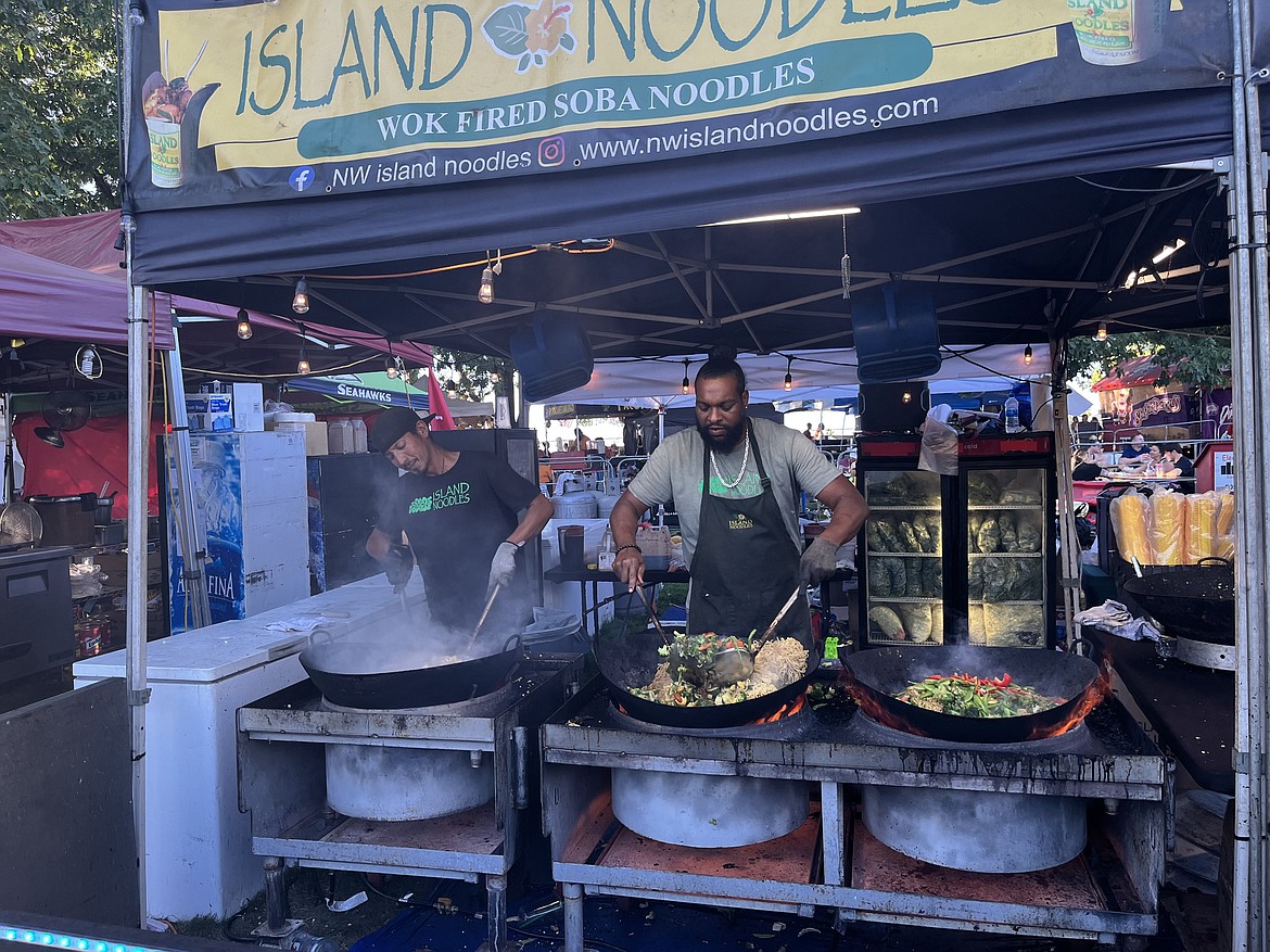 Chefs Jarrett Wong and Stephen Griggs cook inside the Northwest Island Noodles stand. (Courtesy photo)