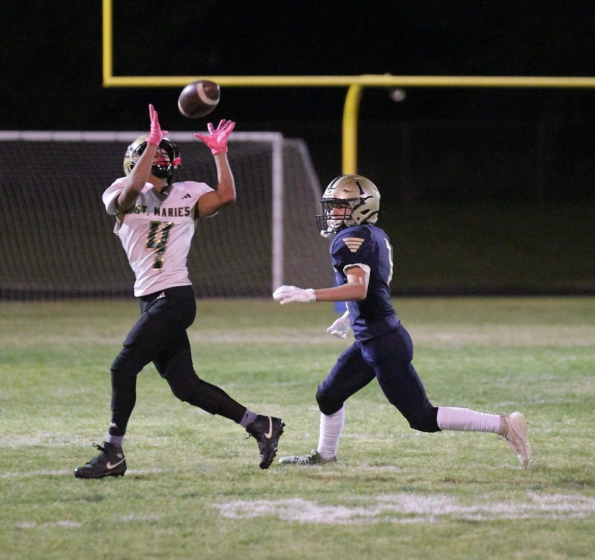 MARK NELKE/Press
Julien Ceja-Grimaldo (4) of St. Maries hauls in a pass as Wade VanGundy (1) of Timberlake defends on Friday night at Van Tuinstra Memorial Field in Spirit Lake.