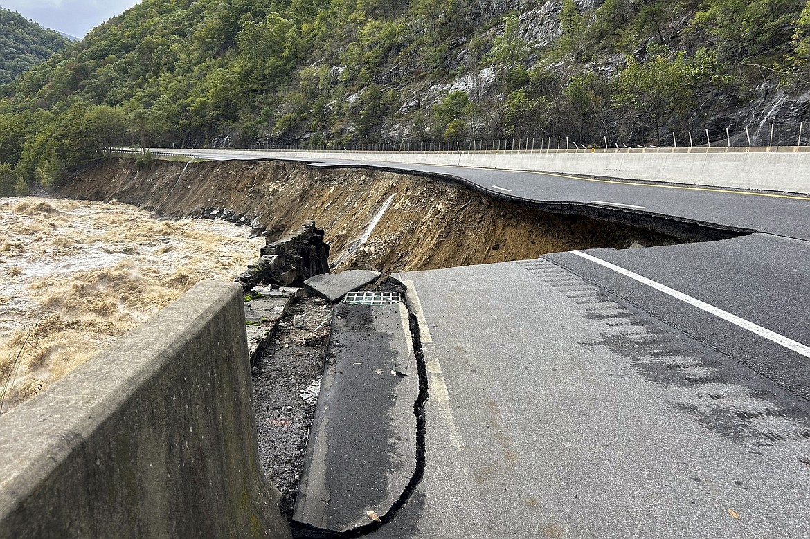 This photo provided by the North Carolina Department of Transportation shows the collapsed eastbound lane of I-40 into the Pigeon River in North Carolina near the Tennessee border on Saturday, Sept. 28, 2024. (N.C. Department of Transportation via AP)