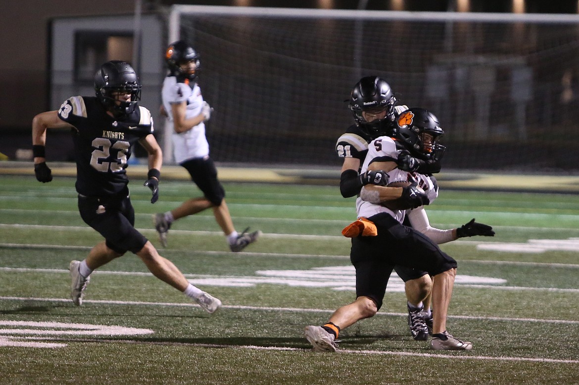 Royal senior Jackson Larsen (21) makes a tackle during the second quarter against Zillah. Larsen intercepted a pass in the first quarter Friday night.