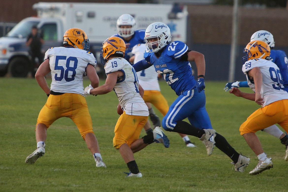 Soap Lake senior Sam Schopf (22) looks to make a tackle in the backfield against a Wellpinit ballcarrier.