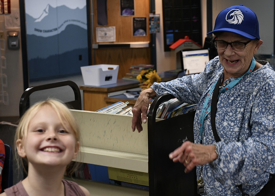 Every Tuesday, Deb Holmes (or Grandma Deb) is part of Sagle Elementary School's support network. When students are having a rough day or missing mom, they count on Grandma Deb's encouraging tone and supportive words. She is a member of Sagle Parent Watch, a volunteer organization that supports student safety and the district's One Trusted Adult initiative. Pictured smiling with Grandma Deb in the school library is second grader Adeline Libbers.