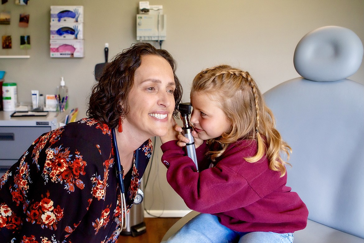 Dr. Kelly Berkram plays with a young patient at her practice Apex Direct Care in Kalispell. (Courtesy photo)