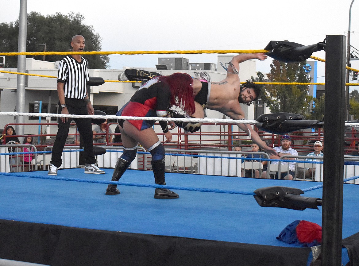 A wrestler identified only as Amazona swings “Thicc” Ricc Rodriguez through the air before slamming him into the canvas at the UMANI Festival Saturday.