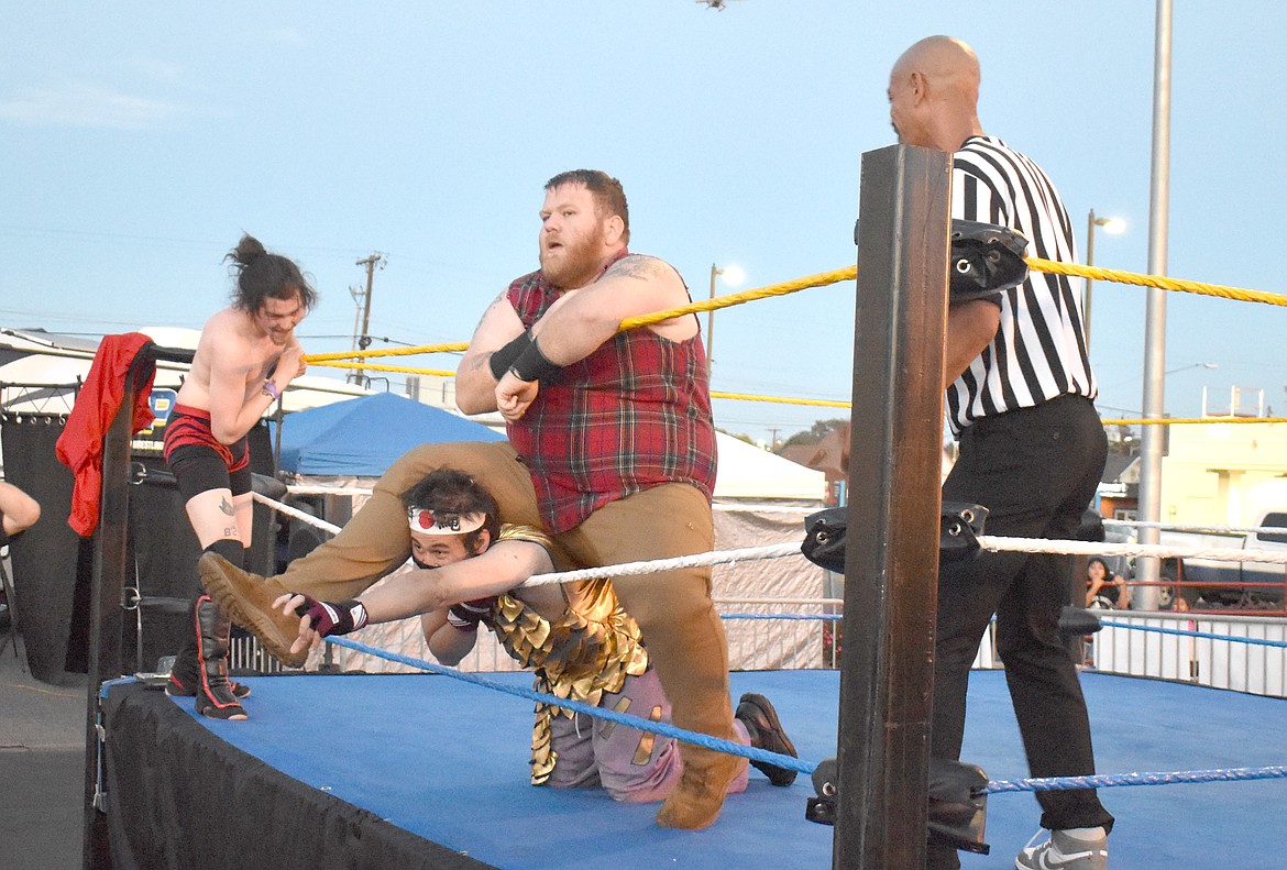 Lumber Zack makes his opponent Ryuki very well acquainted with the rope as Christian Wylde creeps around the outside of the ring at the UMANI Festival Saturday.