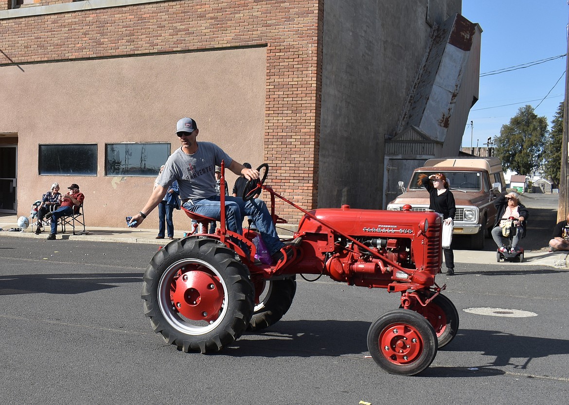 Jason Emerson gets ready to toss a handful of candy at the Almira Country Fair parade Saturday morning.