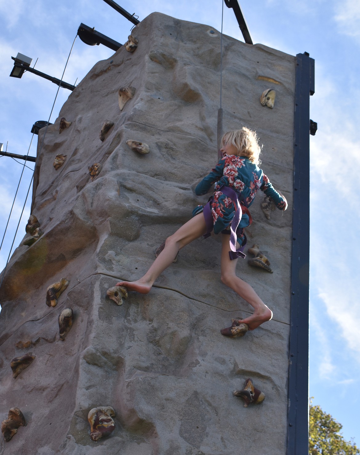 Darnella Yearout, 8, tackles the last stretch of the climbing wall at the Almira Country Fair Saturday.