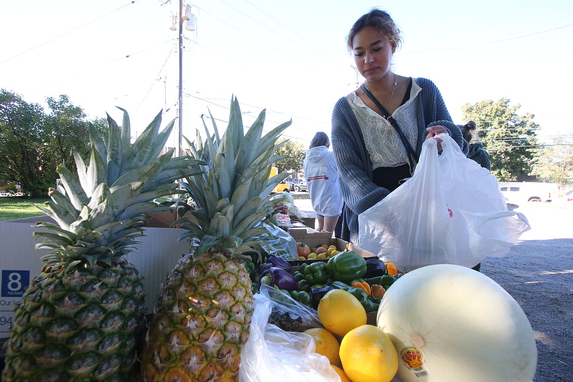 Sydney Adams of Post Falls, who has worked as a baker, a barista and at The Coeur d'Alene Resort, fills a bag with produce Monday morning during a distribution of produce donated by PB and J Haydeners, a mobile distribution nonprofit that grows fresh fruits and vegetables in Hayden. "About 150-350 pounds can come out of our garden,” said Heidi Benson president/chair. "The rest we purchase at the grocery store."