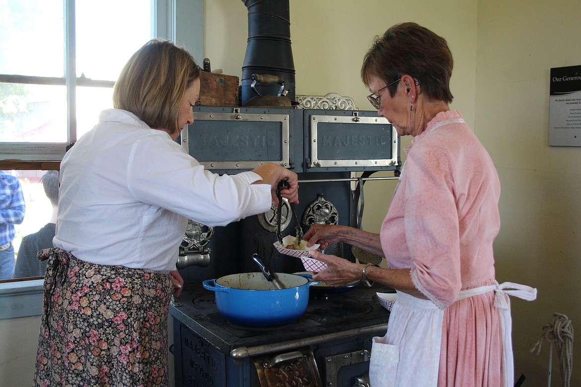 Pam Nutter, left, and Terri Wilson serve sauerkraut and sausage, a reflection of the people of German heritage who helped build Quincy.