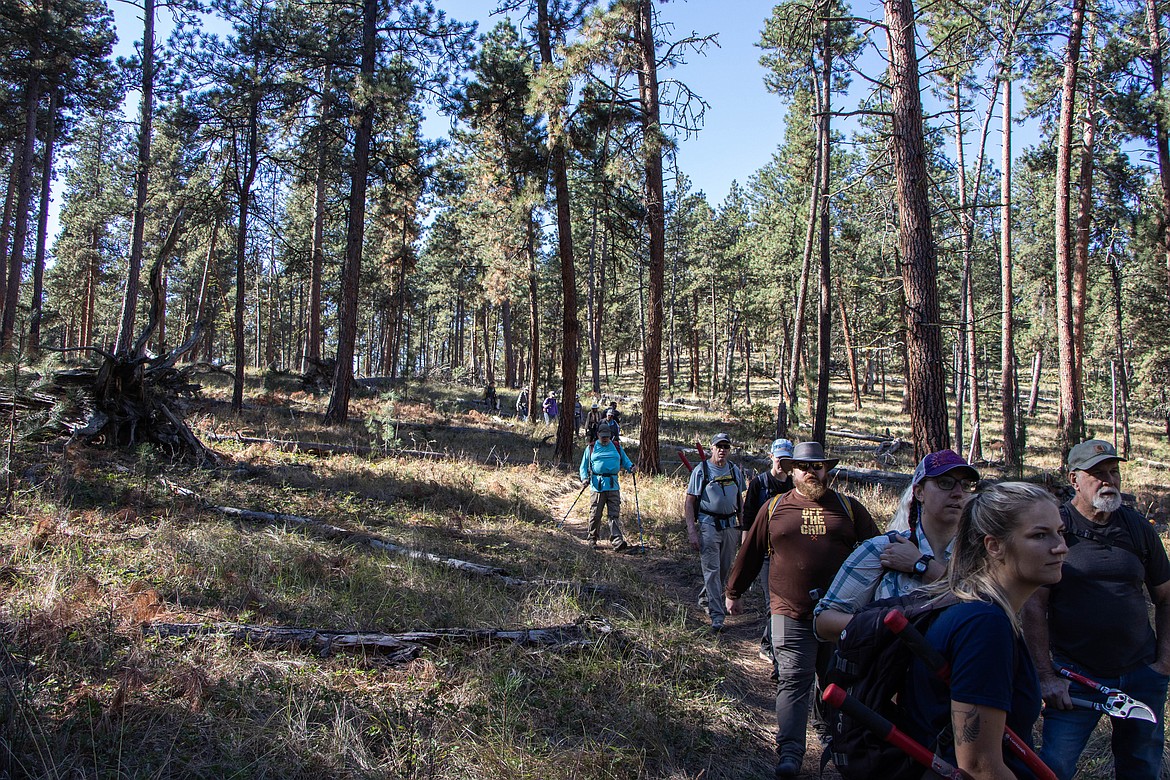 Volunteers hike at a volunteer event on Wild Horse Island through Montana Fish, Wildlife and Parks on Sept. 28, 2024. (Kate Heston/Daily Inter Lake)