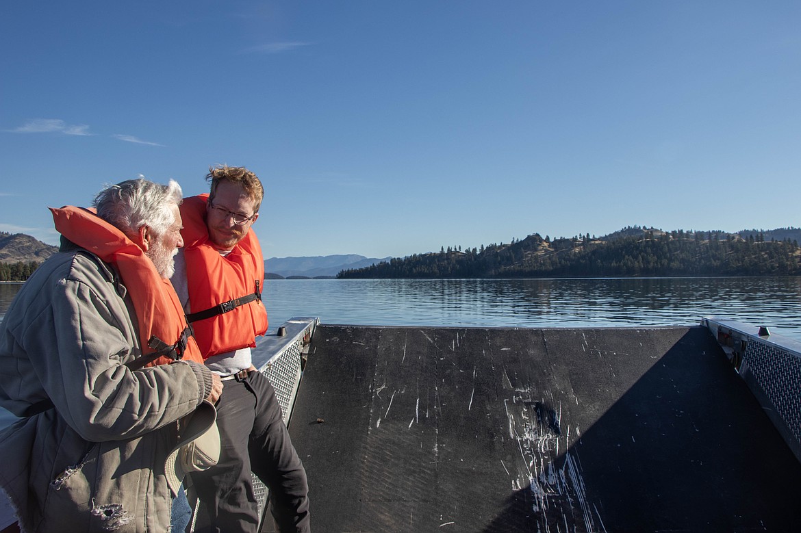 Ranger Zack Story and volunteer Steven Smith speak on the boat at a volunteer event on Wild Horse Island through Montana Fish, Wildlife and Parks on Sept. 28, 2024. (Kate Heston/Daily Inter Lake)