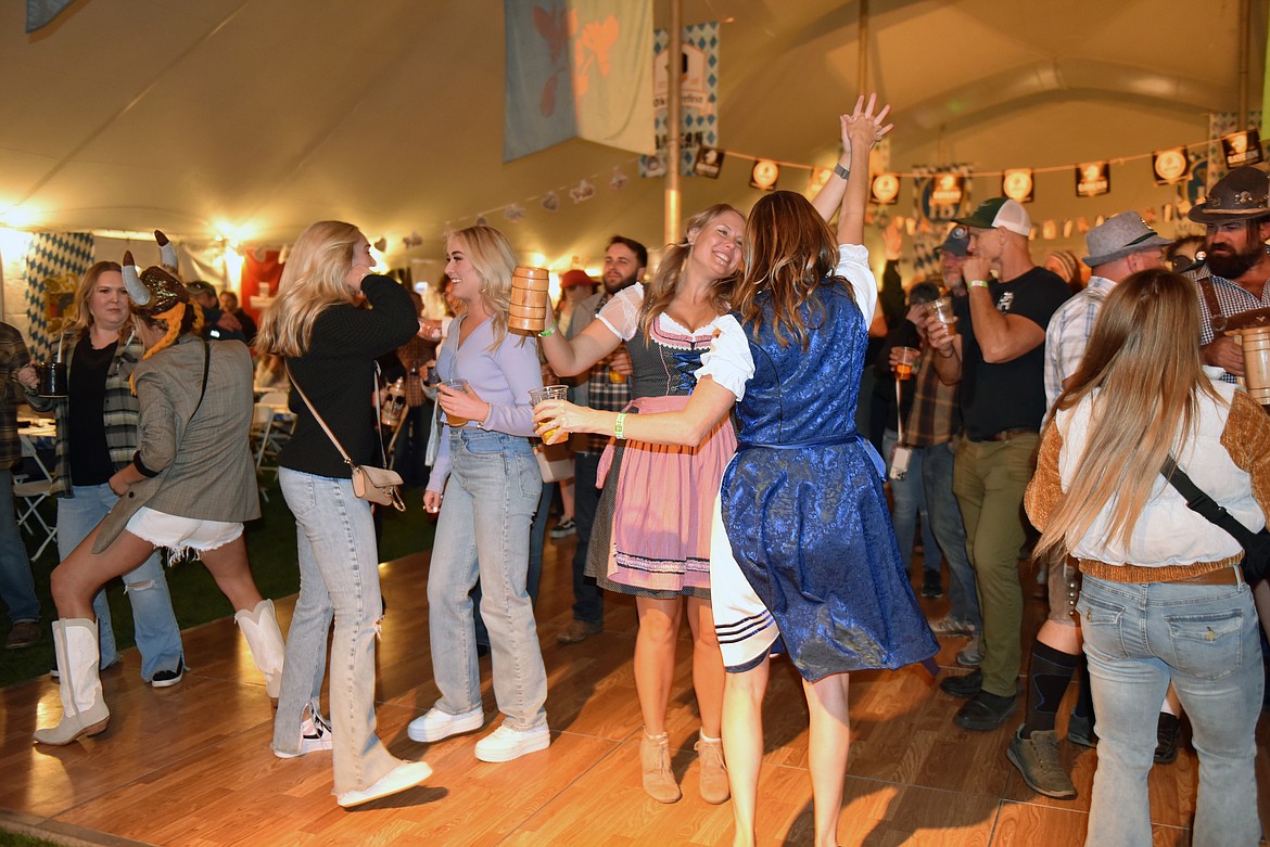 People dance at local's night on the first day of Oktoberfest in Depot Park. (Kelsey Evans/Whitefish Pilot)