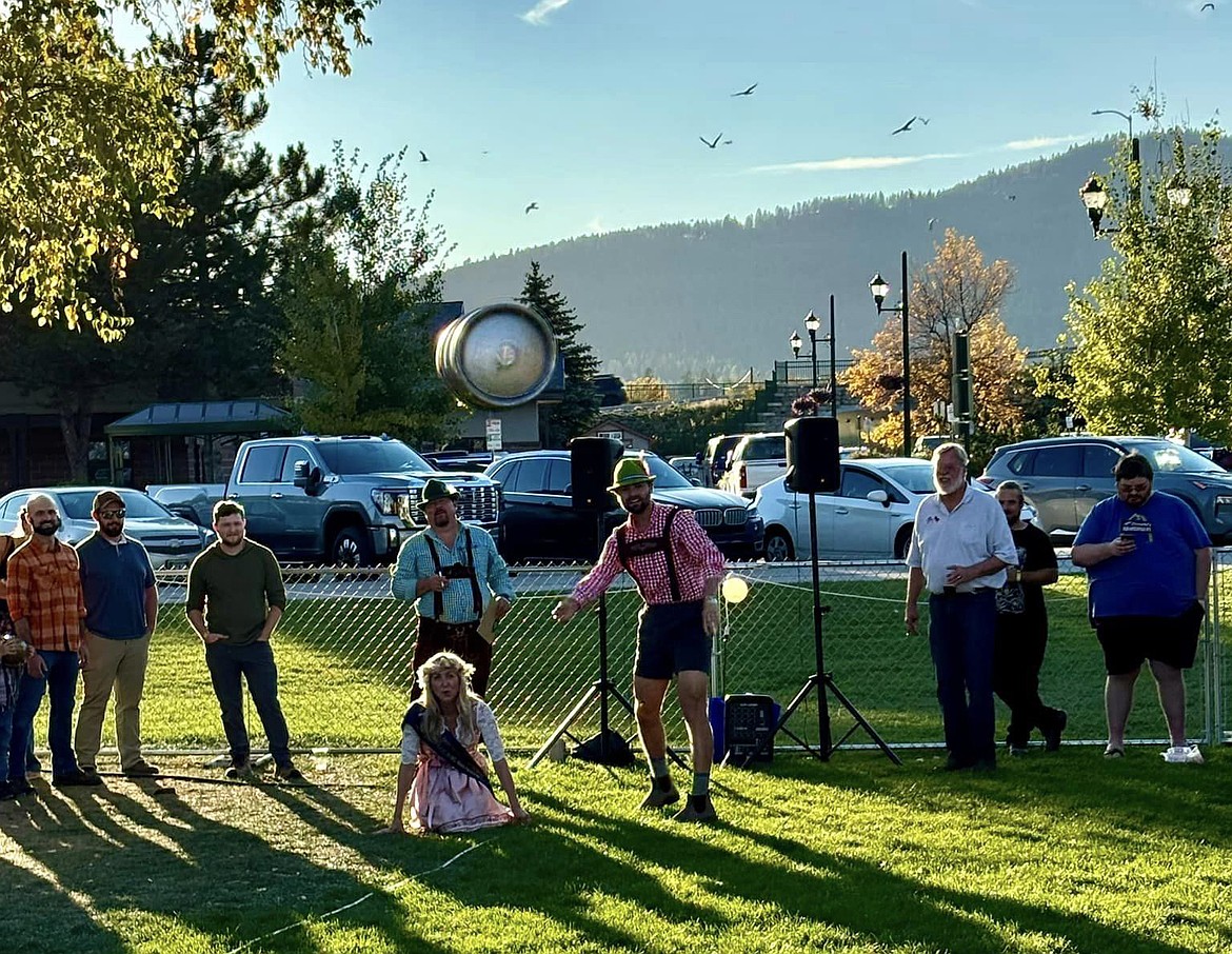 Andrew Benhart hurls a keg at Oktoberfest Saturday while also volunteering at the event. (Whitefish Chamber of Commerce photo)