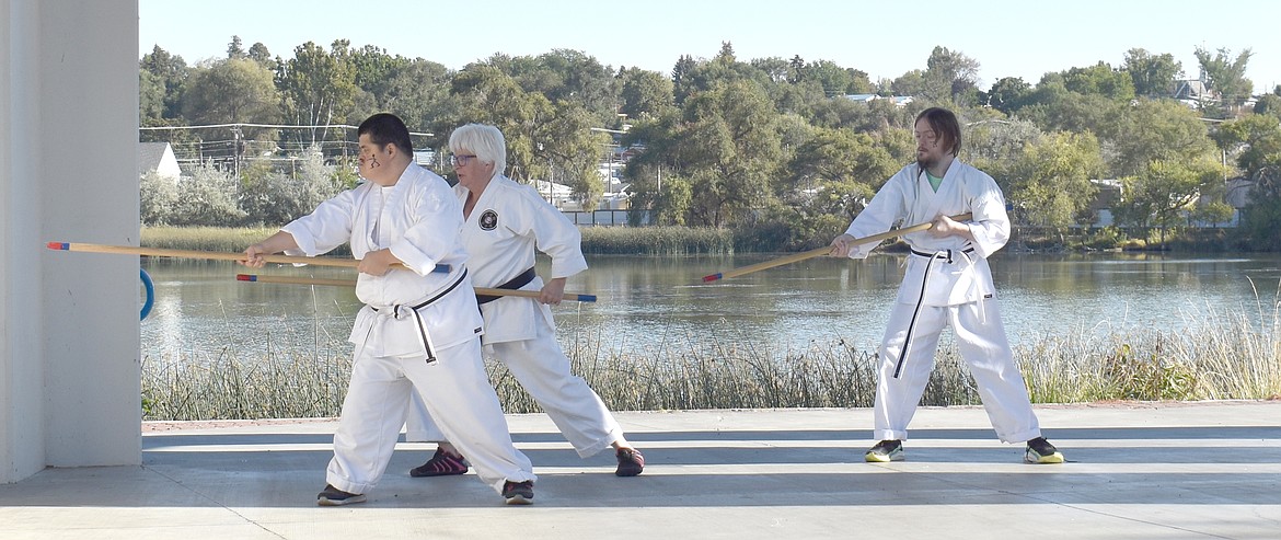 Ricky Ramos, left, and Chase Krenz, right, with their sensei Jill Stone of Basin Karate, give a demonstration at the Buddy Walk Saturday in Moses Lake.