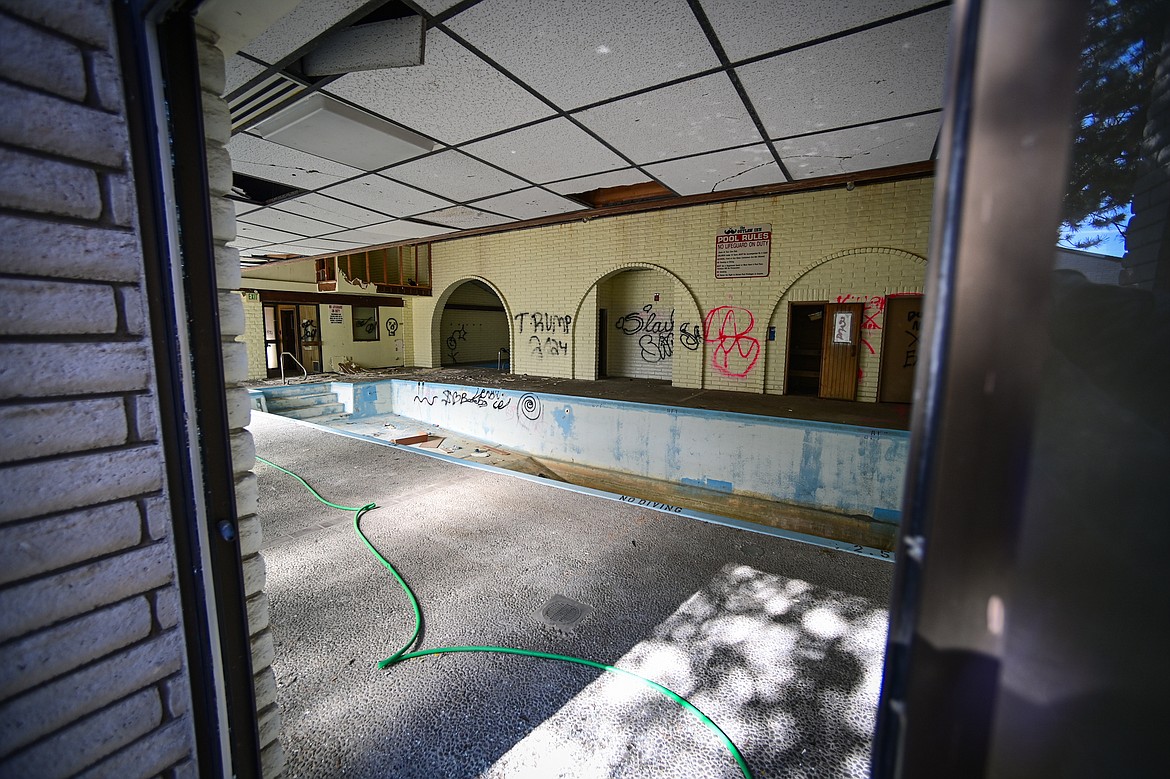 An indoor pool is shown through a smashed sliding glass door at the former Fairbridge Inn & Suites and Outlaw Convention Center in Kalispell on Tuesday, Oct. 1. (Casey Kreider/Daily Inter Lake)