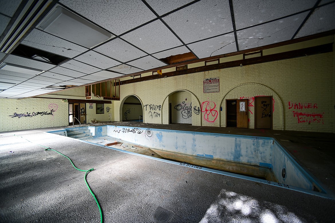 An indoor pool is shown through a smashed sliding glass door at the former Fairbridge Inn & Suites and Outlaw Convention Center in Kalispell on Tuesday, Oct. 1. (Casey Kreider/Daily Inter Lake)