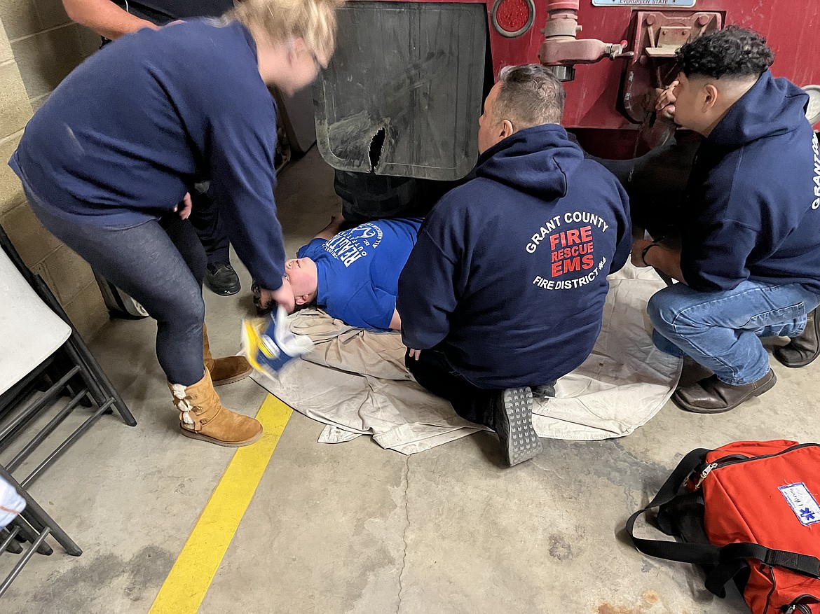 Amy Bargelt’s son, Ray, volunteers as a “victim” during an EMT training. Bargelt works to support local firefighters and EMTs.