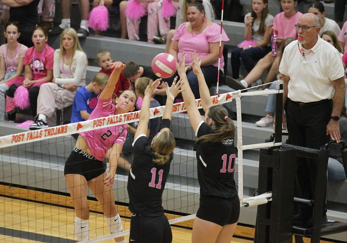 MARK NELKE/Press
Post Falls senior Vanessa Kison (2) hits against the block of junior Gianna Callari (11) and senior Kaydence Green (10) of Coeur d'Alene in the Volleyball 4 the Cure match Tuesday night at Post Falls High.