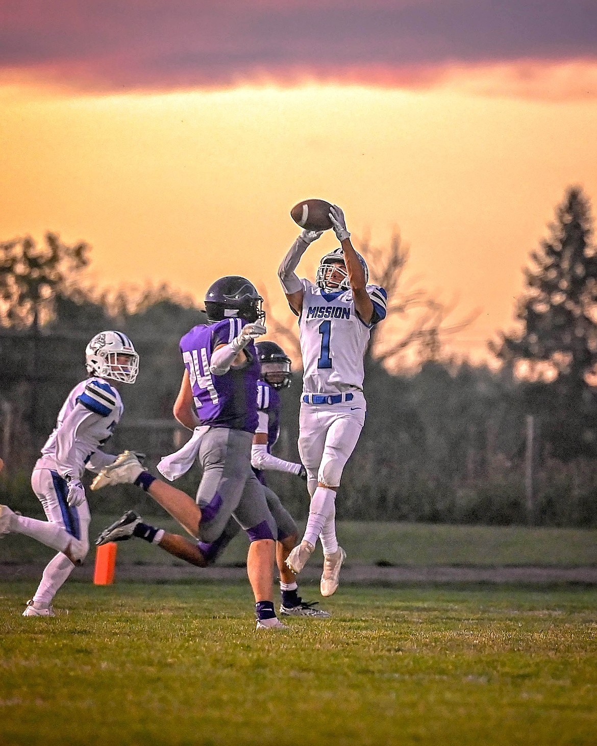 Bulldog Iyezk Umphrey captures the ball at sunset during last week's game against Charlo. (Christa Umphrey photo)