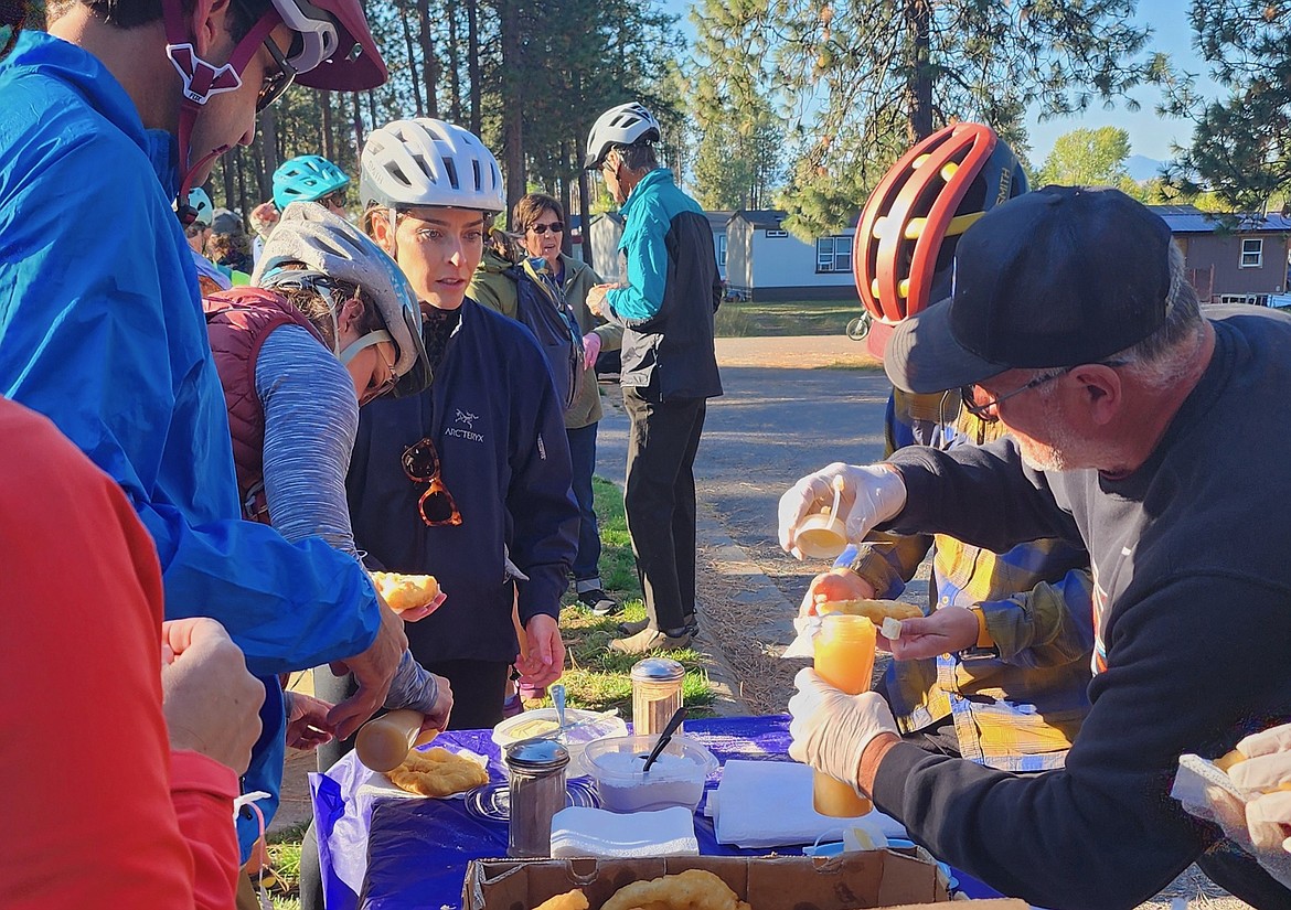 Janice and Ronnie Couture made frybread for the Pedal-to-Plate crowd as a taste of Flathead Reservation culture. And frybread is always better with honey. (Berl Tiskus/Leader)