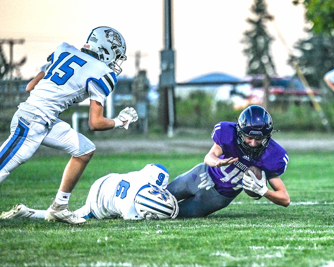 Mission's Titan Mansel and Mack McDonald take down Charlo's Tien Weatherby during last week's game between the valley rivals. (Christa Umphrey photo)