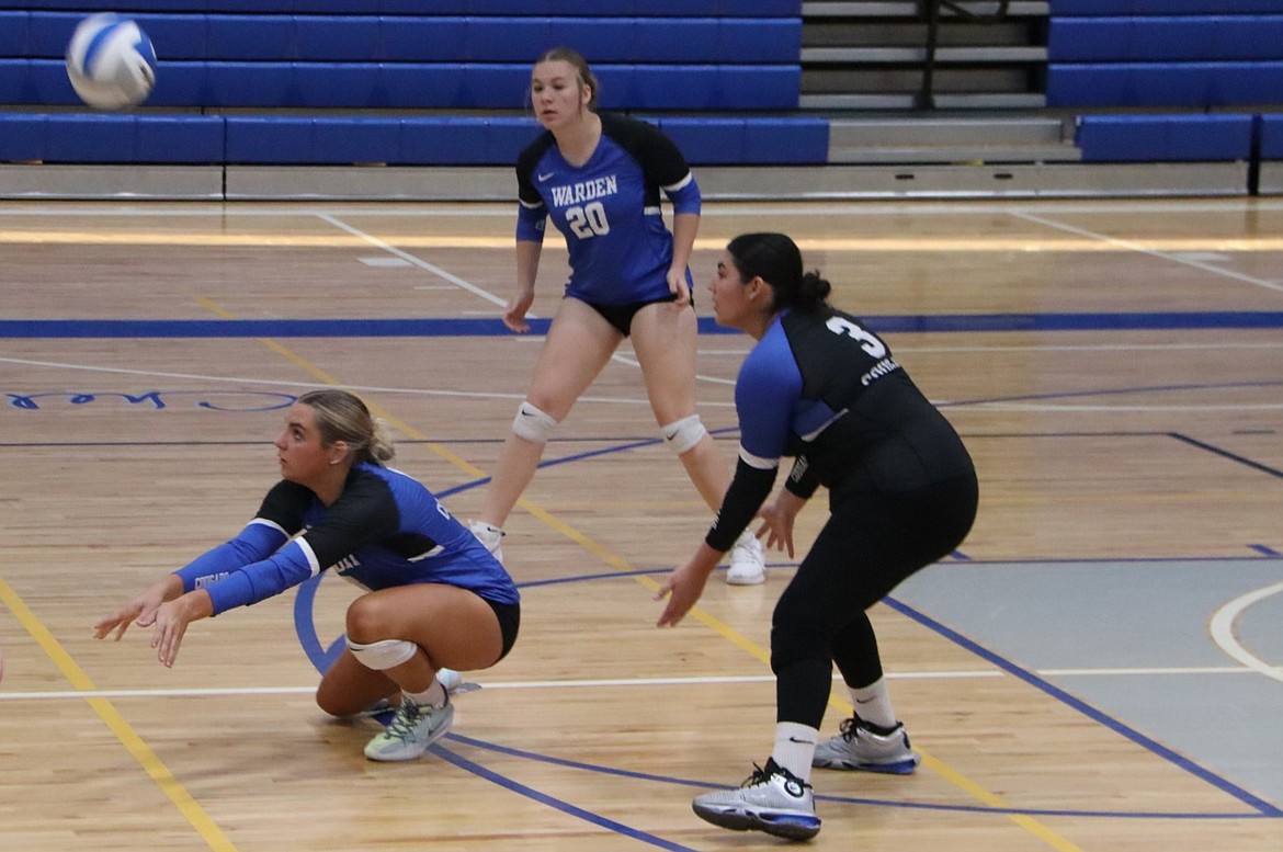 Warden senior Reagan Golladay, left, drops down to bump the ball during a game earlier this season. On Monday against Othello, Golladay recorded nine kills, six digs and five aces in a 3-1 win.