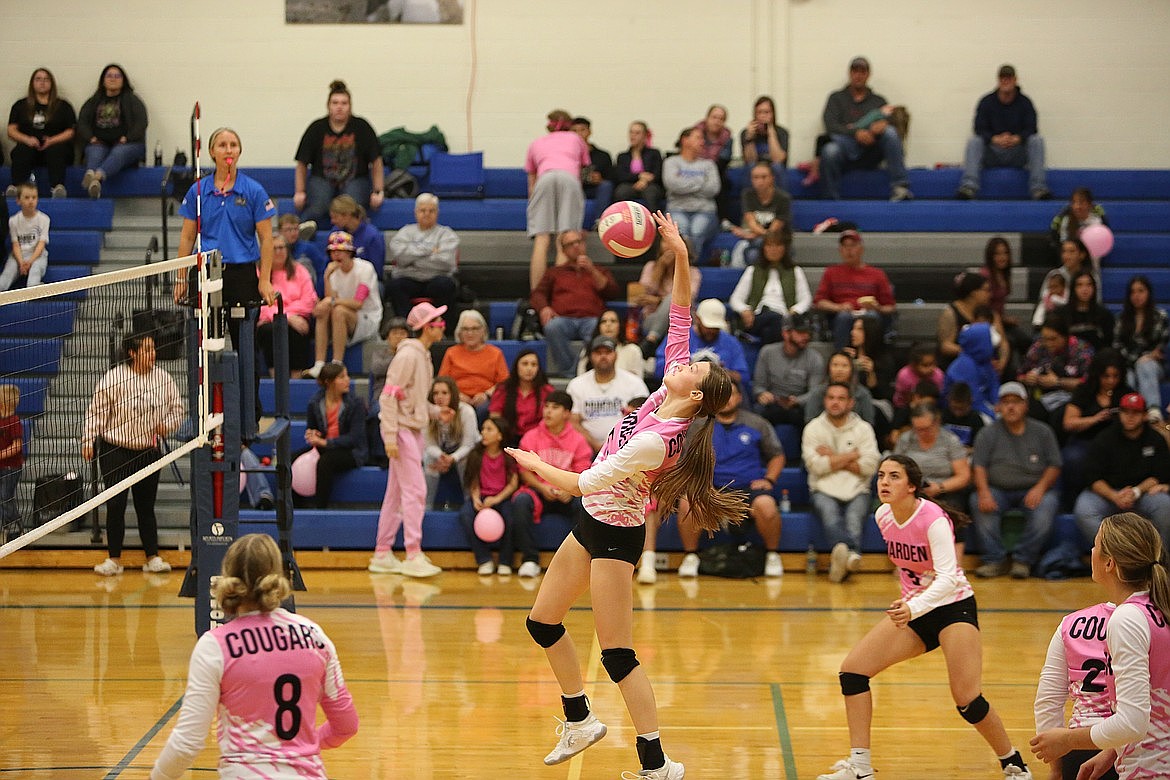 Warden senior Lauren Chamberlain, center, leaps up toward the ball during a game in the 2023 season. Chamberlain recorded 14 kills during Monday’s non-league game against Othello.