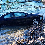 Car and driver rescued from river