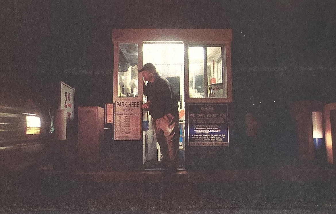 Richard Stemmons at the Third Street parking toll booth amuses himself and motorists by whistling in 2004.