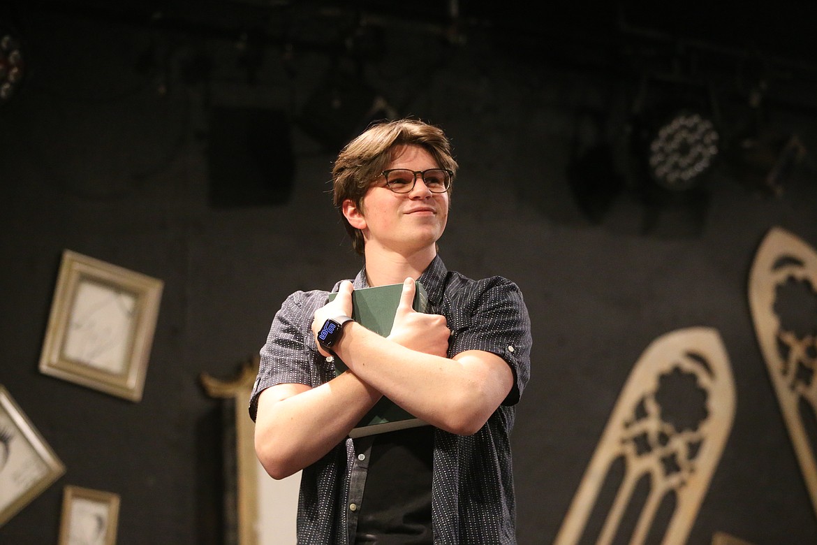 Actor Abe McKinney hugs a tome of William Shakespeare's works during rehearsal Tuesday.