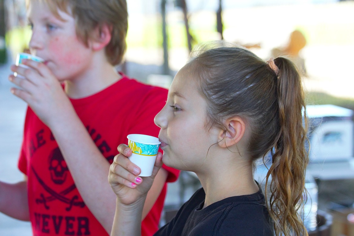 Youth sample apple cider at the North Idaho Bear Fair.