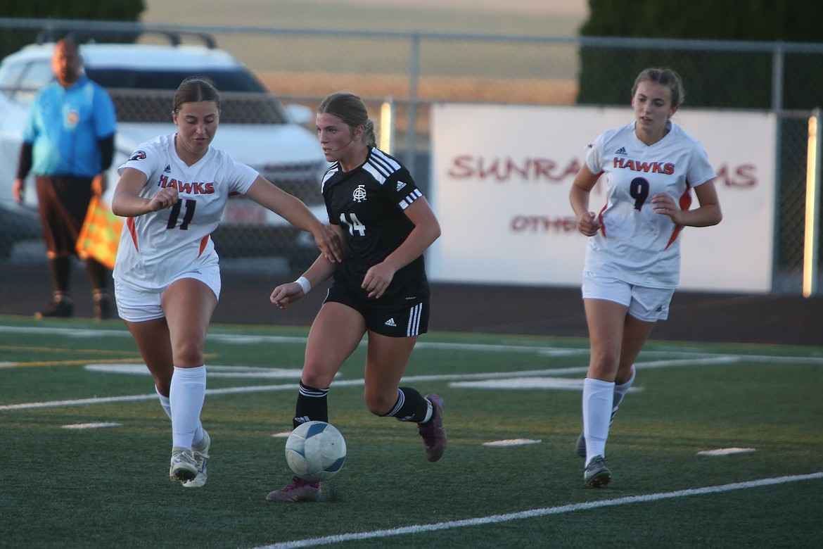 Royal sophomore Maggie Frank (14) looks for a teammate to pass the ball to during the first half of Tuesday’s match against College Place. Frank scored a goal in the 77th minute to help seal the win.