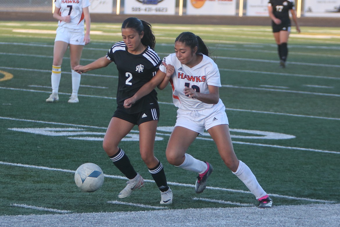 Royal freshman Bella Villafana (2) battles with a College Place player for possession of the ball during the first half of Tuesday’s match against the Hawks.