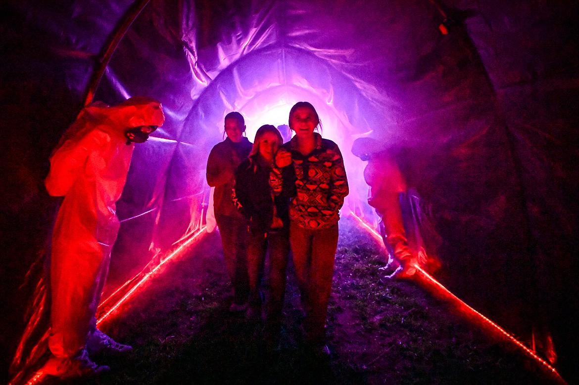 Participants navigate a section of the Glacier Gallows Halloween experience at Glacier Ziplines on Wednesday, Oct. 2. (Casey Kreider/Daily Inter Lake)