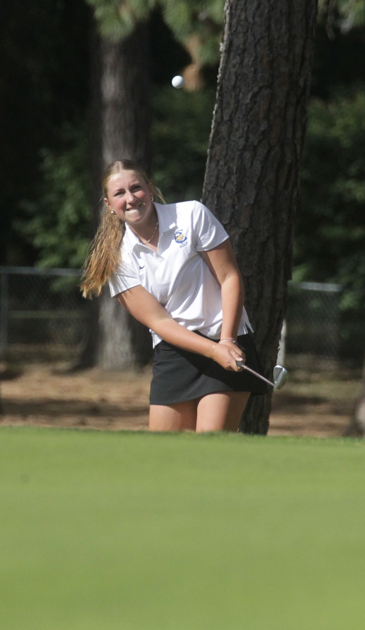 MARK NELKE/Press
Coeur d'Alene High freshman Ella Wilson watches her chip shot on the 12th hole at the Coeur d'Alene Golf Club on Thursday, during the 6A District 1 tournament. Wilson was medalist with a 5-over-par 77.