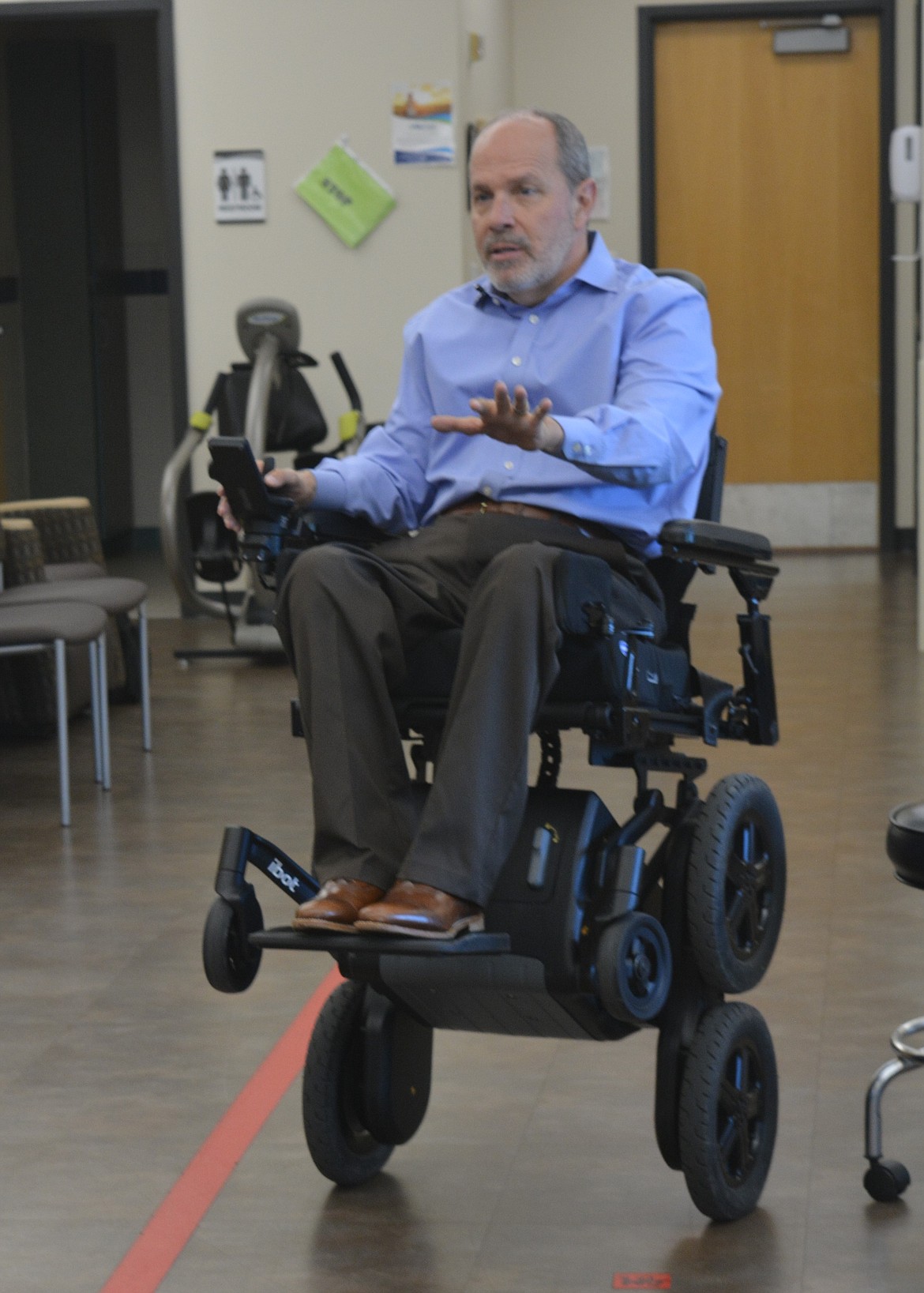 Glen House talks about how mobility devices like the iBOT powerchair offer more options for fellow wheelchair users Thursday at Kootenai Health. The wheelchair can go all-terrain and pick up over curbs without outside assistance.