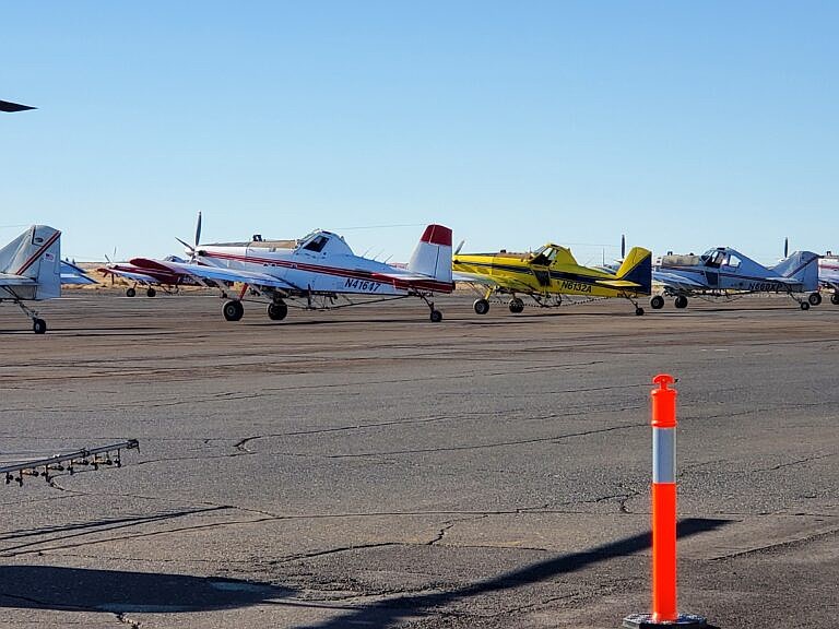 Agricultural aircraft in line at the Port of Ephrata during last year's fly-in put on by the Association of Washington Aerial Applicators. Visitors will be able to check them out close up at Friday's event.