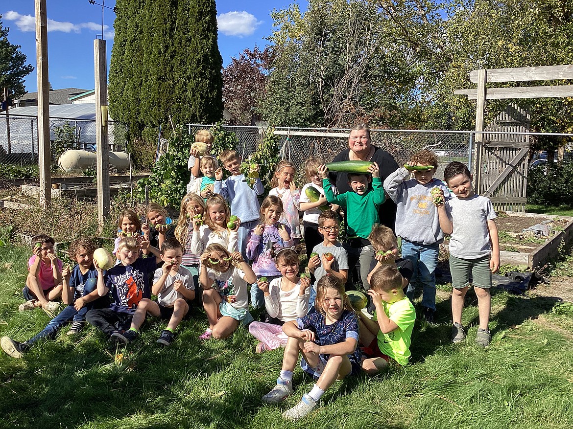 Jessica Osborne's first grade students at Hayden Meadows show off greenhouse produce during a group photo Oct. 2.