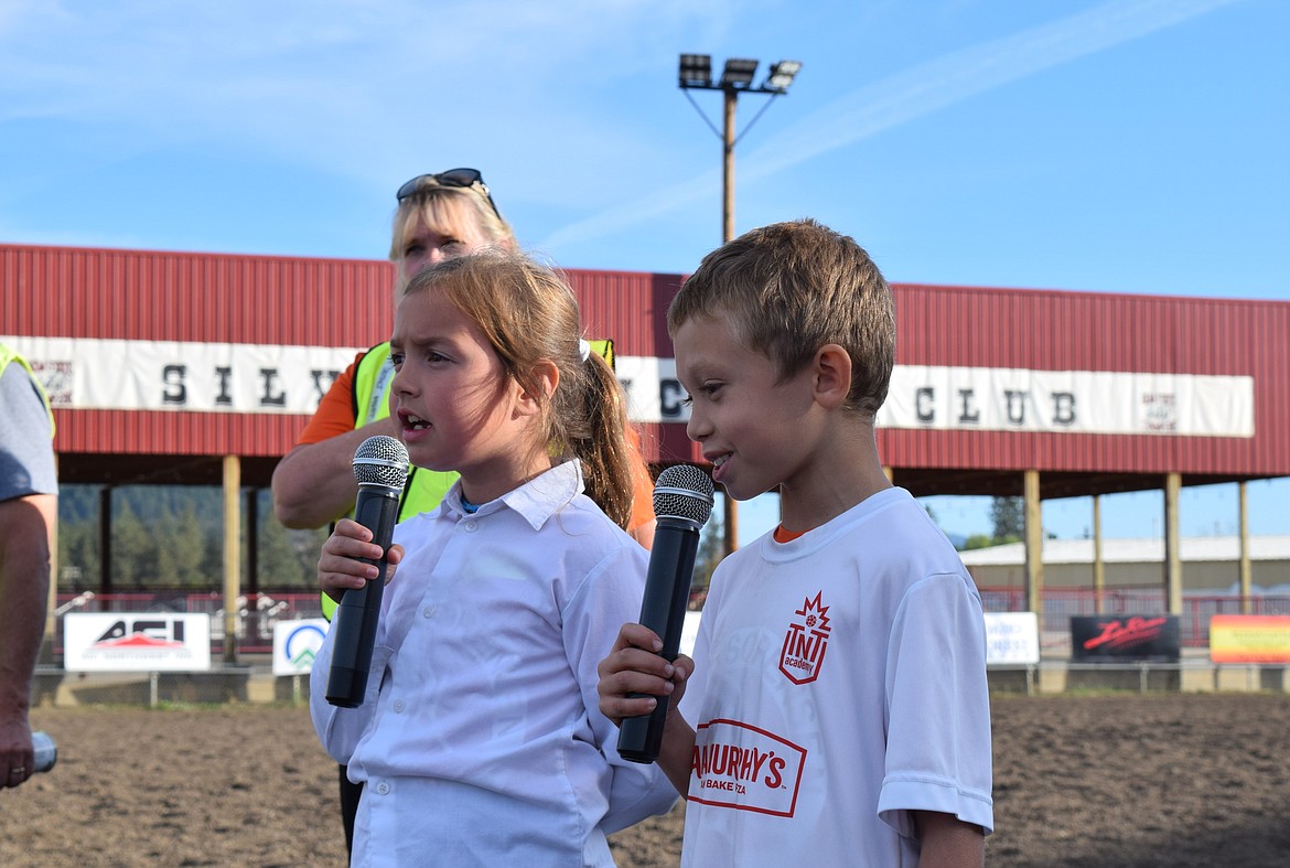 Emma Weinberger and Xander Werner sing the national anthem ahead of Thursday's CDA School District Cross Country Meet.