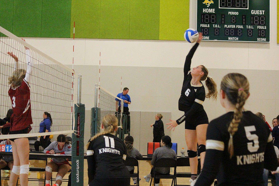 Royal senior Campbelle Anderson (6) rises up to hit the ball over the net at last weekend’s Quincy Invitational volleyball tournament.