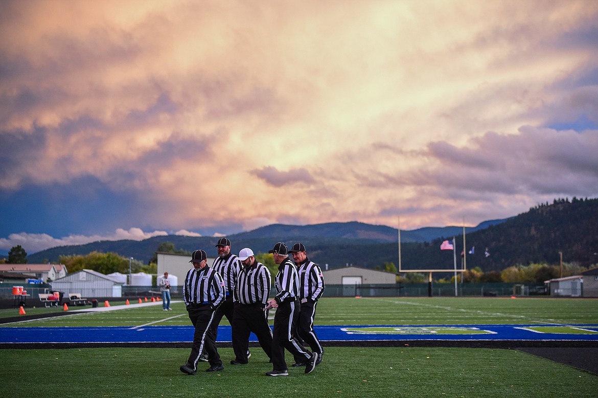 Referees walk across the field before power was restored to Legends Stadium before Flathead's game against Helena on Friday, Oct. 4. (Casey Kreider/Daily Inter Lake)