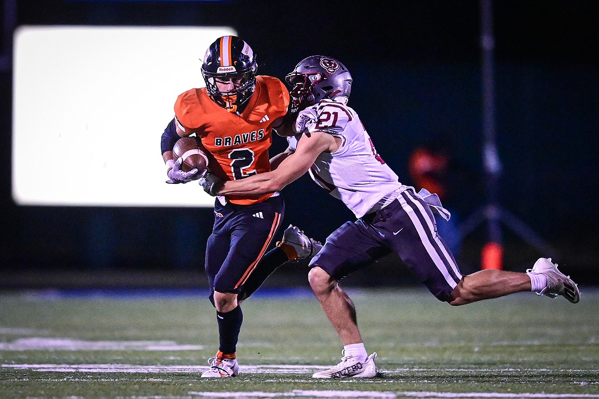 Flathead wide receiver Ben Bliven (2) fights for extra yardage after a reception in the second quarter against Helena at Legends Stadium on Friday, Oct. 4. (Casey Kreider/Daily Inter Lake)