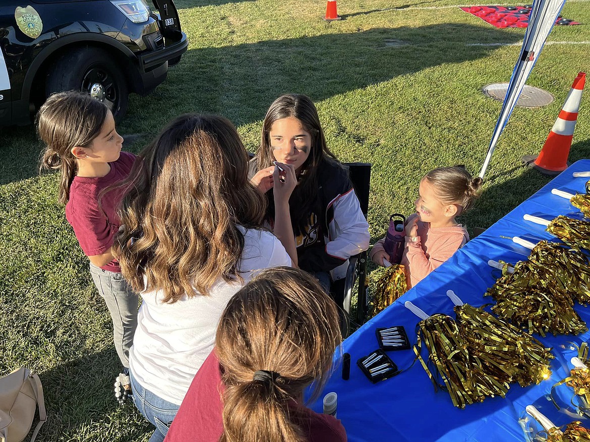 An attendee at last year’s Faith & Blue event sits still for some face paint. Face painting will be a part of this year’s tailgate as well, which is Friday.