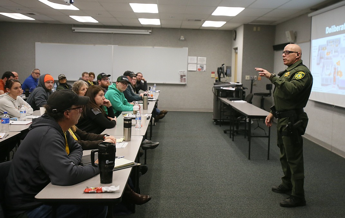 About 40 people listen to Deputy Doug Goodman of the Kootenai County Sheriff's Office as he discusses active shooter training during Safety Fest of the Great Northwest at the Workforce Training Center in Post Falls in 2023.