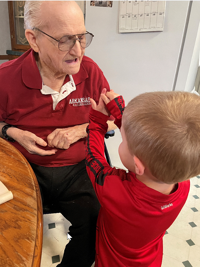 A veteran interacts with a child at a residence that participates in the Veterans Affairs medical foster care home program.