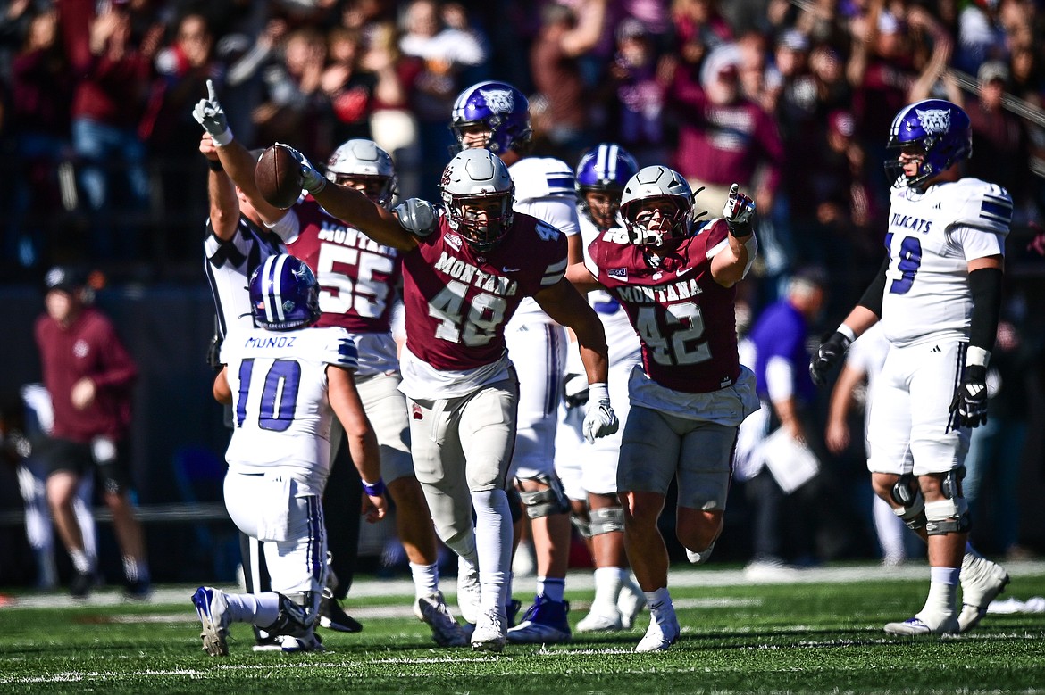 Grizzlies defenders Hayden Harris (48) and Riley Wilson (42) celebrate after Harris sacked Weber State quarterback Richie Munoz causing a fumble which Harris recovered in the second quarter at Washington-Grizzly Stadium on Saturday, Oct. 5. (Casey Kreider/Daily Inter Lake)